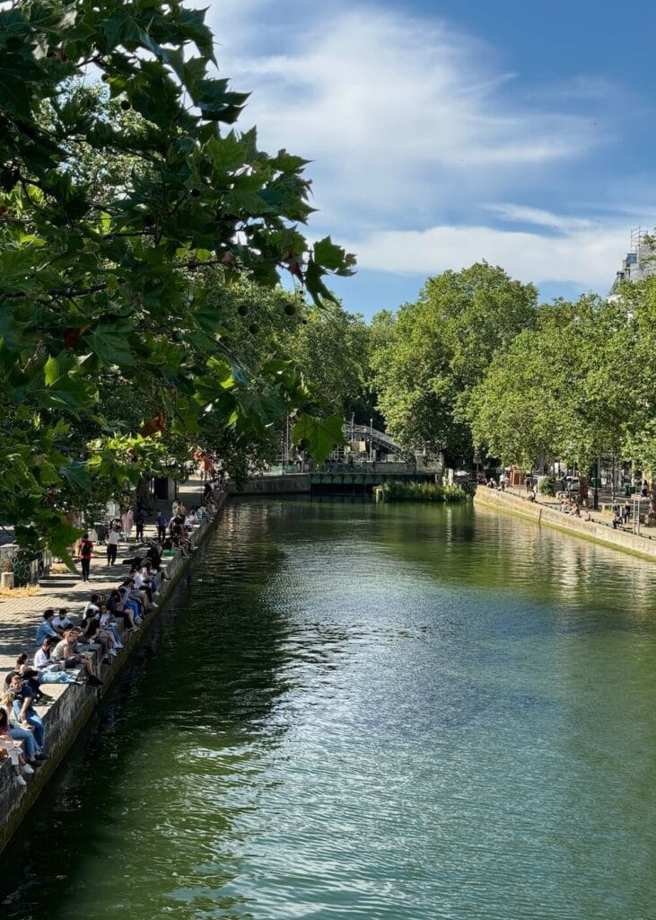 parisians along canal st martin in summer