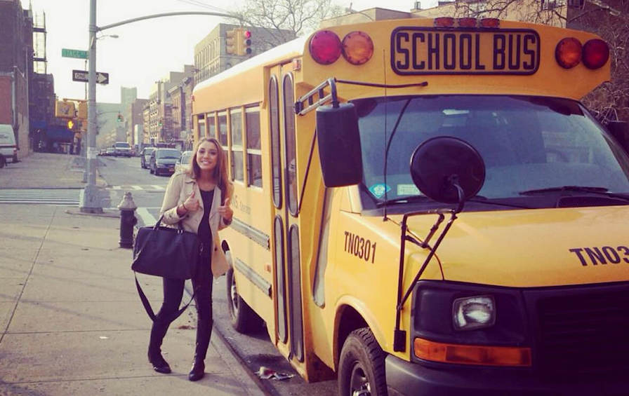 woman next to yellow school bus brooklyn new york