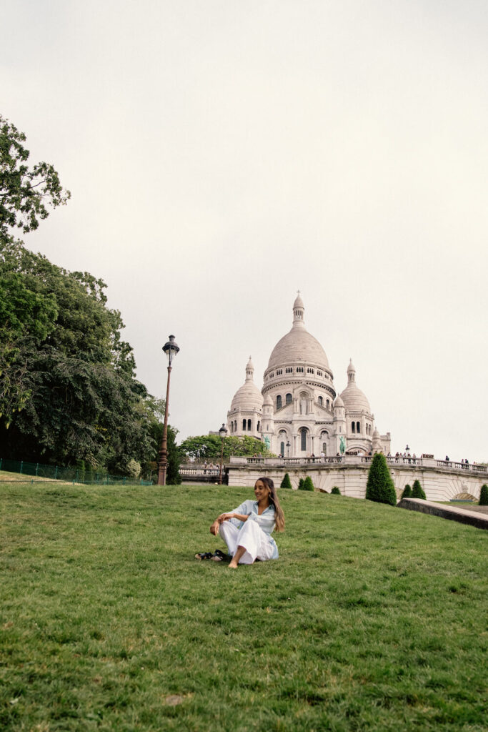 sacre coeur woman sitting on grass