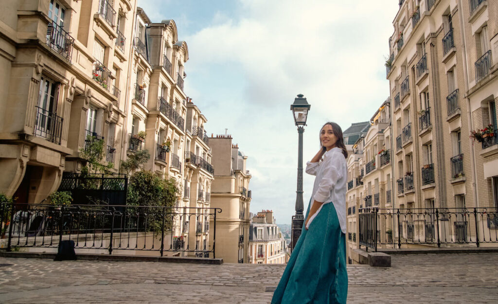 woman blue dress white shirt in streets of paris