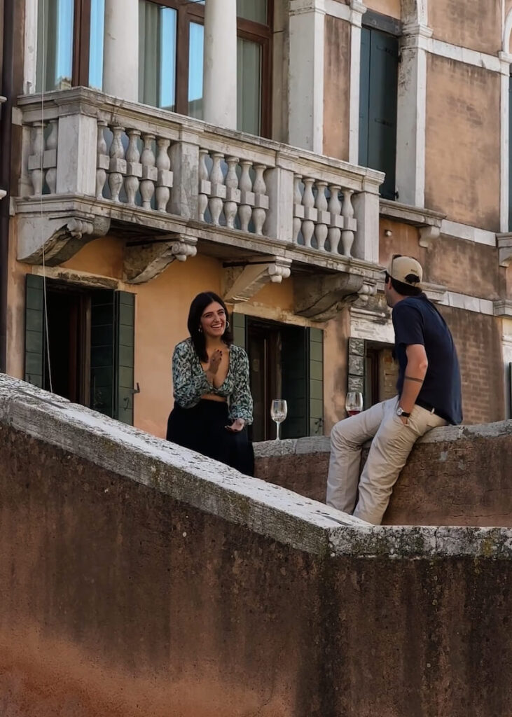 venice bridge couple drinking wine