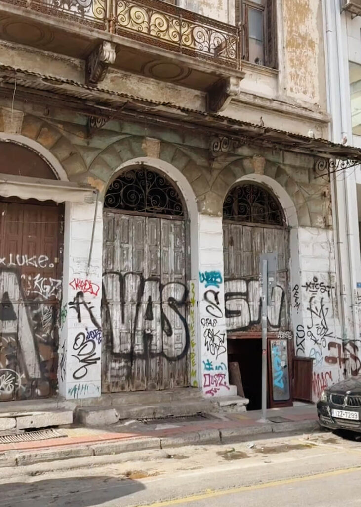 diporto athens restautant outside graffiti covered wall entrance