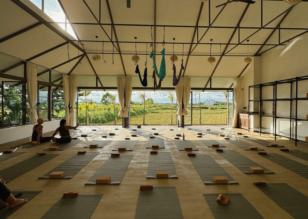 sun filled yoga studio hoi an vietnam with rice field view