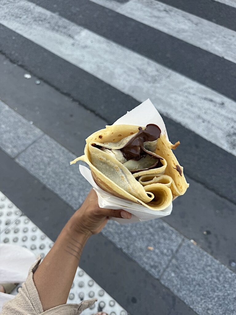 nutella crepe in hand of woman, france