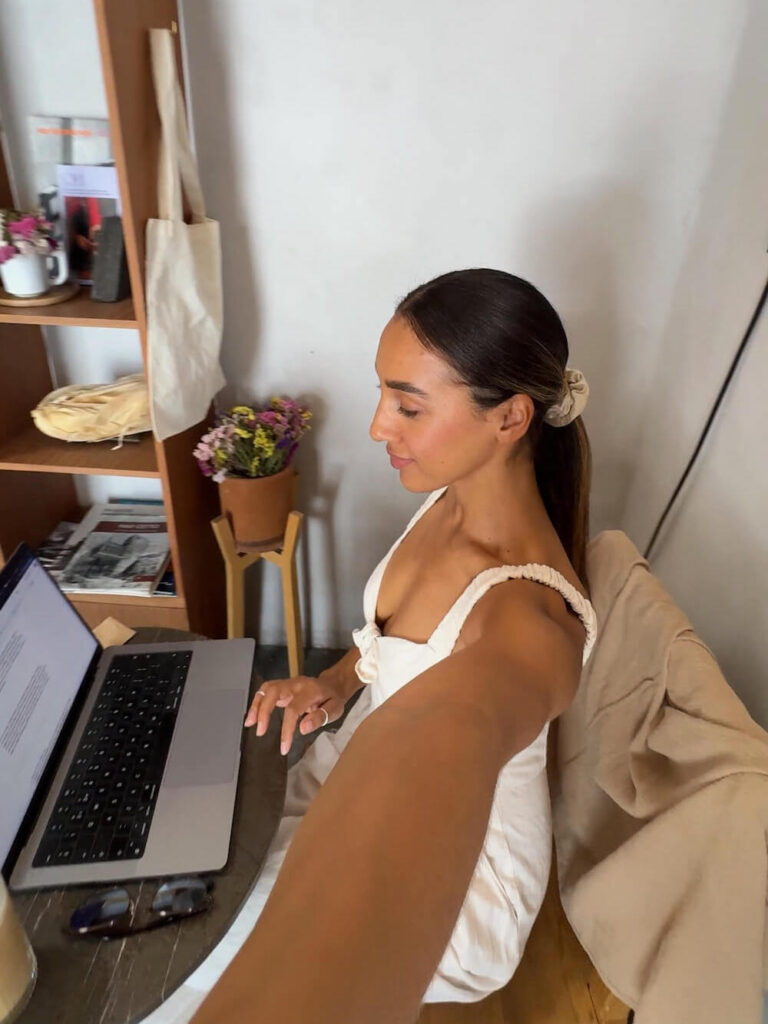 digital nomad woman working from a cafe on laptop in a cafe
