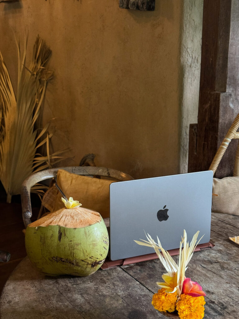 laptop with fresh coconut in cafe in ubud bali