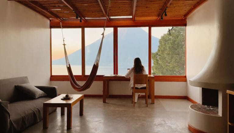 working working on laptop with volcano view in guatemala lake atitlan