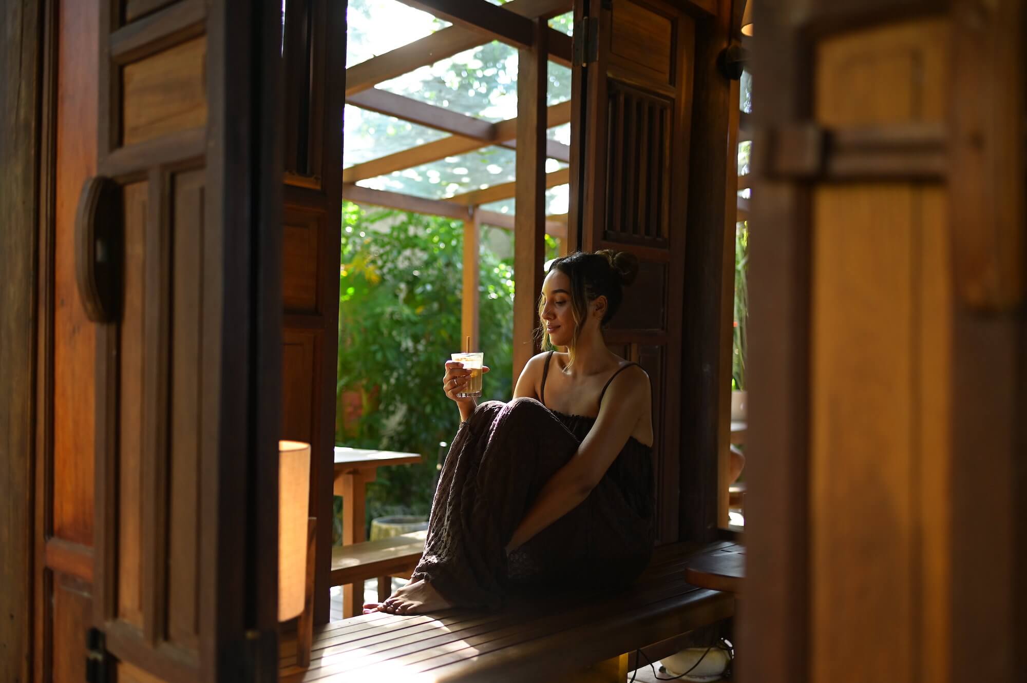 woman sitting in cafe with coffee hoi an vietnam