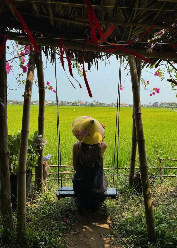Person on swing in rice fields