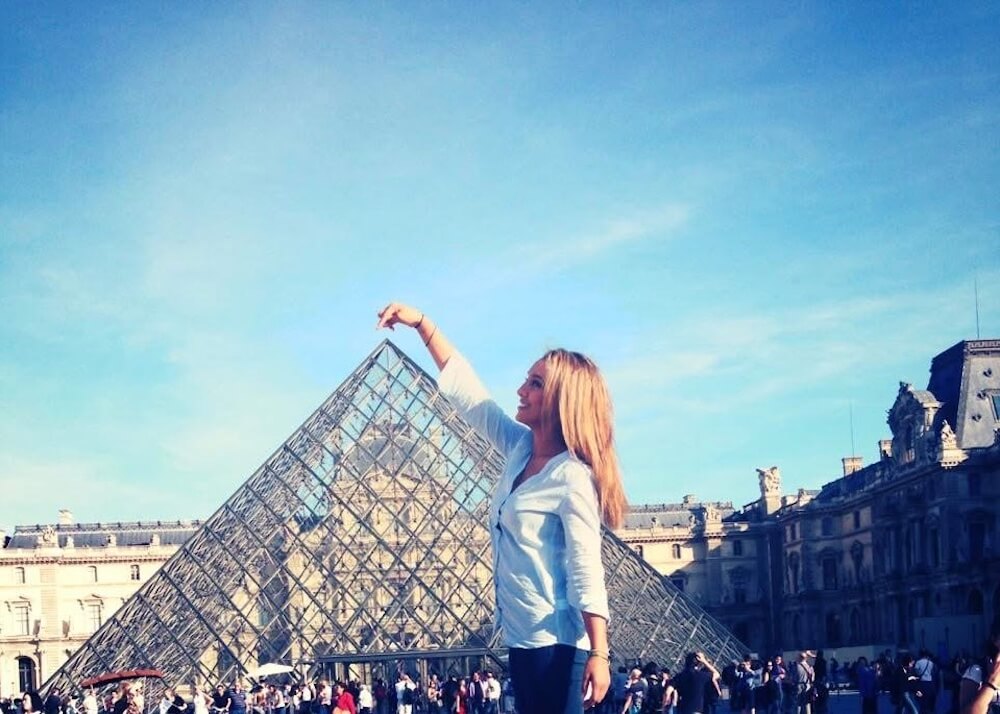 woman paris louvre blue sky