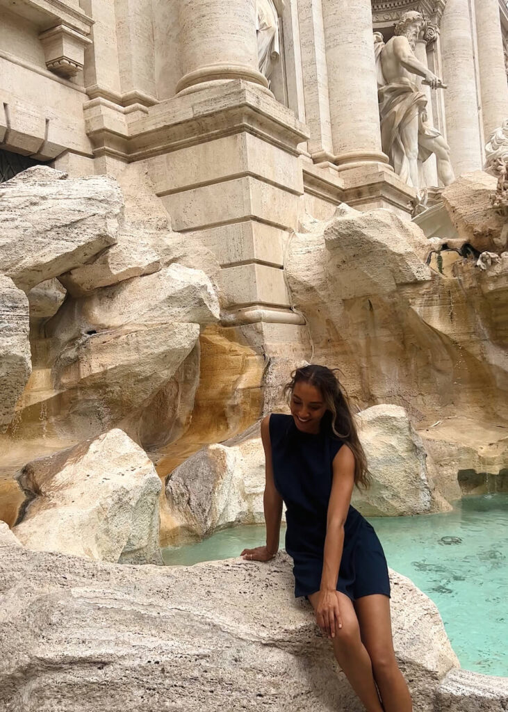 woman in front of trevi fountain rome italy