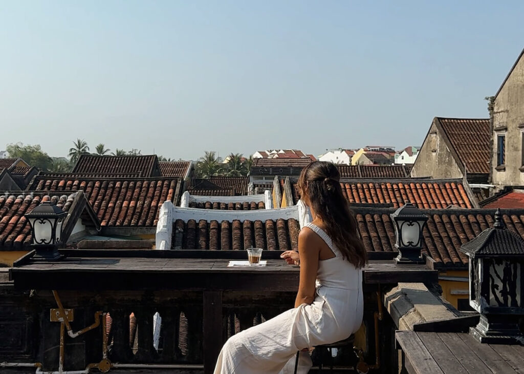 woman sat rooftop cafe hoi an vietnam, travel decision fatigue